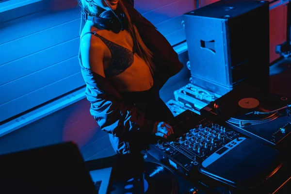 Cropped view of dj girl touching equalizer on dj mixer — Stock Photo