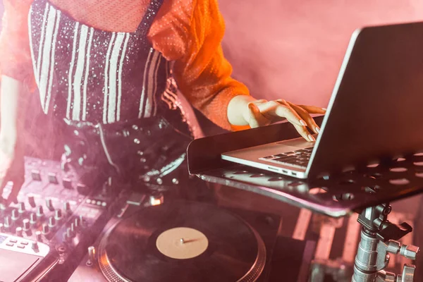 Ausgeschnittene Ansicht von DJ-Mädchen mit Laptop in Nachtclub mit Rauch — Stockfoto