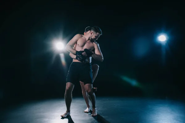 Mma fighter doing clinch to another sportsman behind back during training — Stock Photo