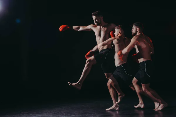 Multiple exposure of strong shirtless muscular mma fighter in boxing gloves doing punch in jump — Stock Photo