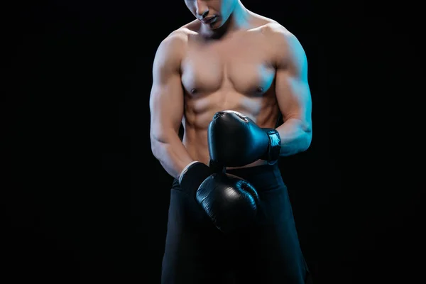 Visão parcial do boxeador sem camisa muscular em luvas de boxe isoladas em preto — Fotografia de Stock