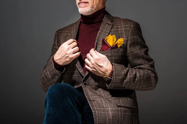 Cropped view of fashionable mature man on grey — Stock Photo