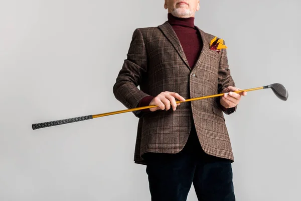 Cropped view of trendy mature man holding golf club and while standing isolated on grey — Stock Photo