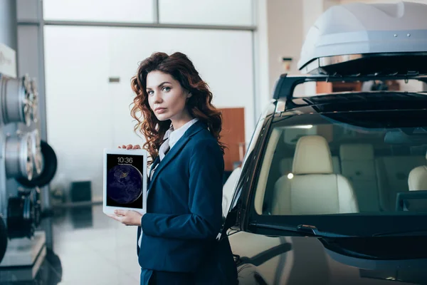 Confident businesswoman holding digital tablet with ipad lock on screen and looking at camera — Stock Photo