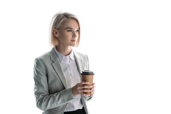 Beautiful, pensive businesswoman holding paper cup and looking away isolated on white — Stock Photo