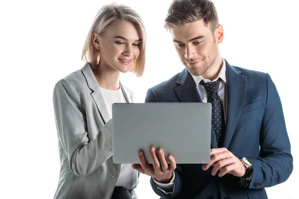 Smiling businesswoman and cheerful businessman using digital laptop isolated on white — Stock Photo