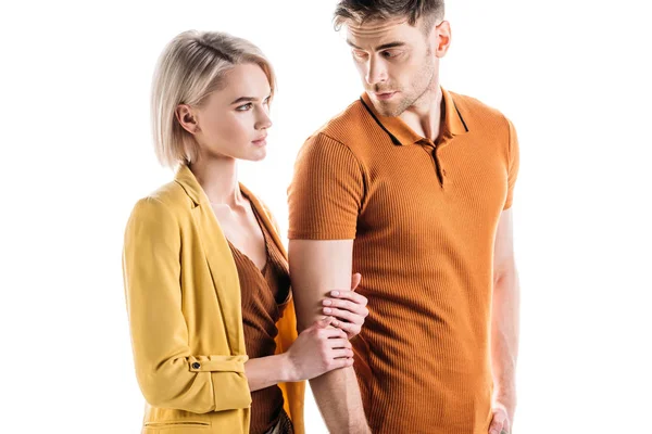 Handsome serious man looking at pretty blonde woman isolated on white — Stock Photo