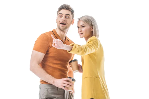 Pretty young woman pointing with finger while standing near handsome man isolated on white — Stock Photo