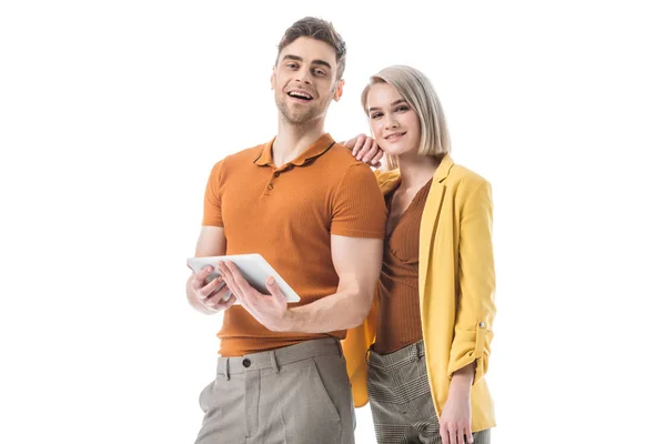 Attractive blonde woman standing near handsome man with digital tablet isolated on white — Stock Photo