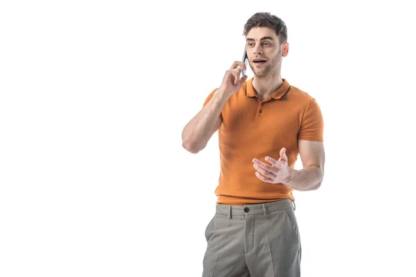 Cheerful handsome man talking on smartphone and gesturing isolated on white — Stock Photo