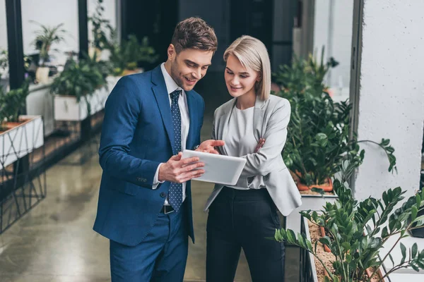 Bella donna d'affari e bell'uomo d'affari utilizzando tablet digitale insieme — Foto stock