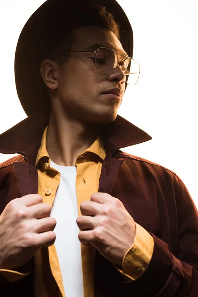 Fashionable mixed race man in sunglasses and hat posing isolated on white — Stock Photo