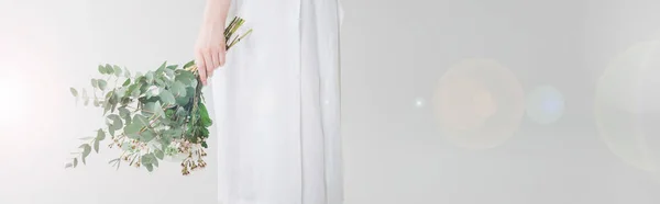 Panoramic shot of girl in dress holding flowers on white — Stock Photo