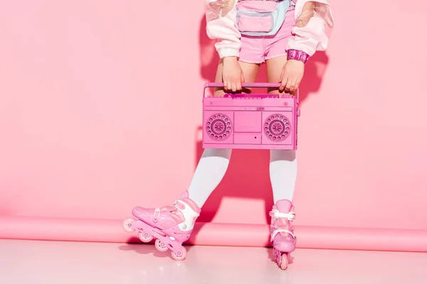 Cropped view of girl in long socks holding retro boombox on pink — Stock Photo