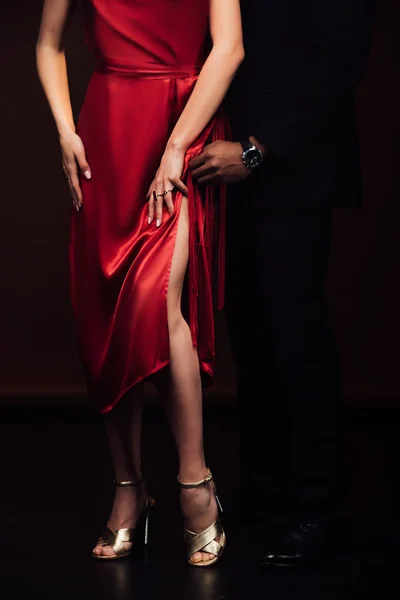 Cropped view of interracial couple in formal wear posing isolated on black — Stock Photo