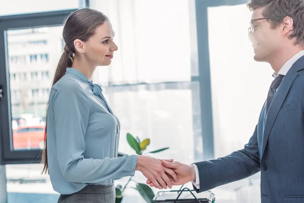 Attractive woman shaking hands with recruiter in glasses — Stock Photo