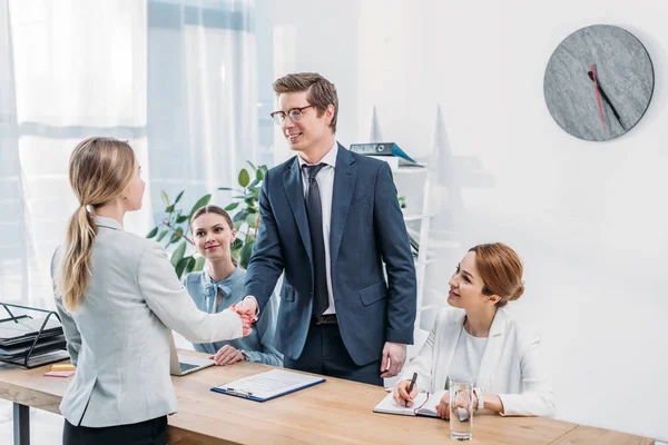 Cheerful man in glasses shaking hands with recruiter on job interview — Stock Photo