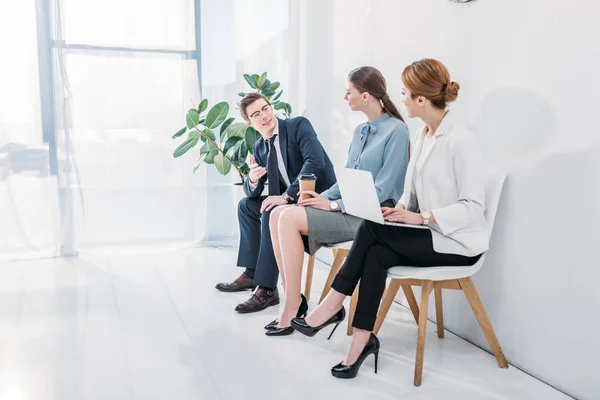 Handsome man in glasses talking with attractive women waiting job interview — Stock Photo