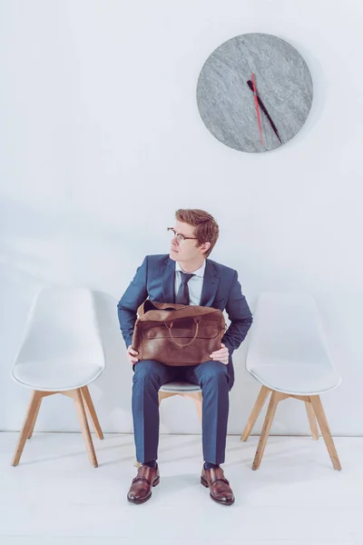 Worried man in glasses holding briefcase while waiting job interview — Stock Photo