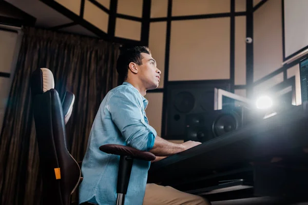 Handsome mixed race sound producer working in recording studio — Stock Photo