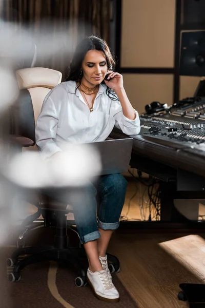 Selective focus og thoughtful sound producer using laptop in recording studio — Stock Photo