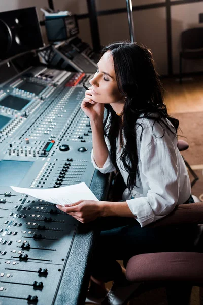 Beautiful dreamy sound producer working in recording studio at mixing console — Stock Photo