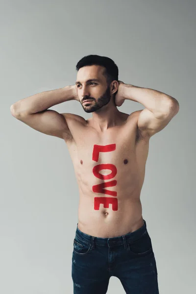Shirtless bearded man with inscription on body isolated on grey — Stock Photo