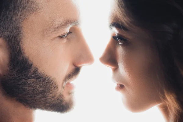 Cropped view of loving couple looking at each other isolated on white — Stock Photo