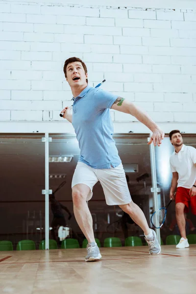 Full length view of two sportsmen playing squash in four-walled court — Stock Photo