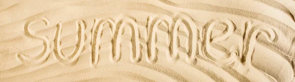 Panoramic shot of word summer written on wavy sand — Stock Photo