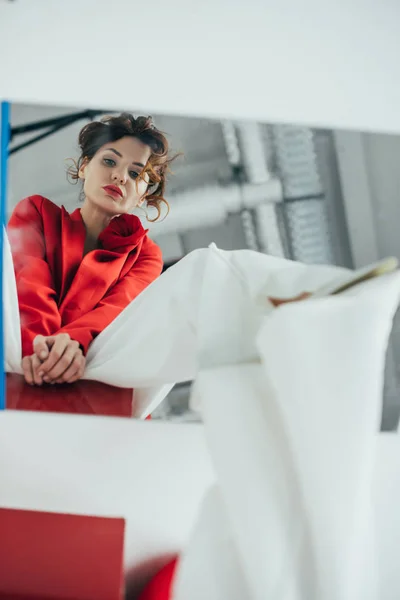 Selective focus of stylish pretty woman looking at mirror on white — Stock Photo