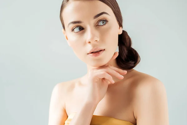 Young dreamy woman with shiny lips and golden eye shadow isolated on grey — Stock Photo