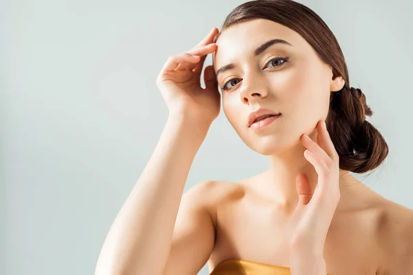 Joven hermosa mujer con labios brillantes y sombra de ojos dorada aislada en gris — Stock Photo