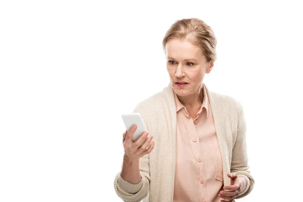 Confused middle aged woman using smartphone Isolated On White — Stock Photo