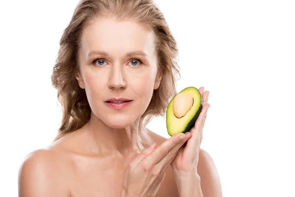 Красивая обнаженная женщина средних лет, позирующая с авокадо на белом — стоковое фото