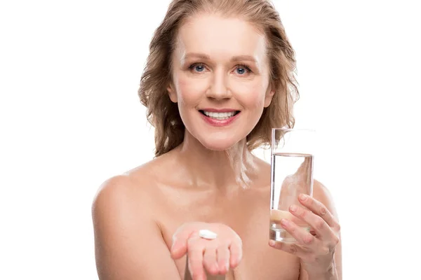 Nude mature woman with glass of water and pills Isolated On White — Stock Photo