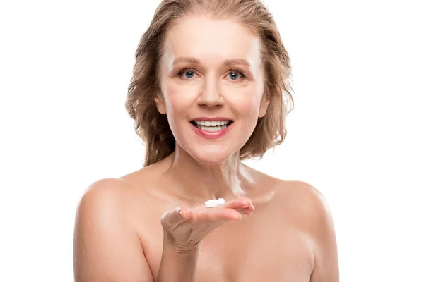Nude mature woman holding pills and smiling Isolated On White — Stock Photo