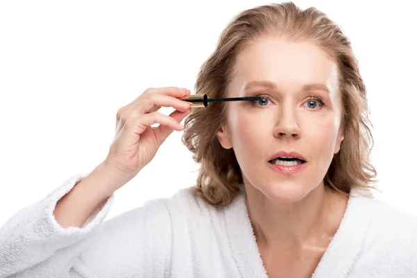 Beautiful mature woman applying mascara Isolated On White — Stock Photo