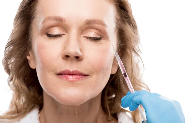 Doctor giving beauty injection to middle aged woman with closed eyes Isolated On White — Stock Photo