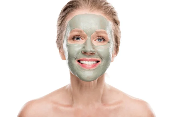 Smiling mature woman with clay mask looking at camera Isolated On White — Stock Photo