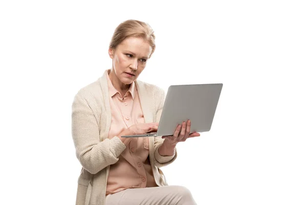 Confused middle aged woman using laptop Isolated On White — Stock Photo