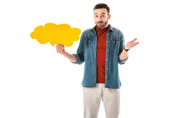 Discouraged handsome man with thought bubble looking at camera and showing shrug gesture isolated on white — Stock Photo