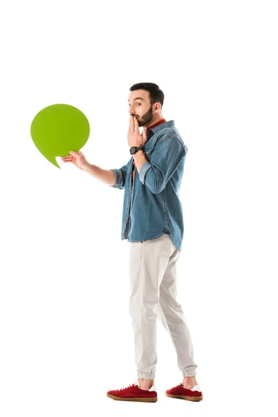 Homem bonito surpreso com pensamento bolha segurando mão perto da boca isolado no branco — Fotografia de Stock