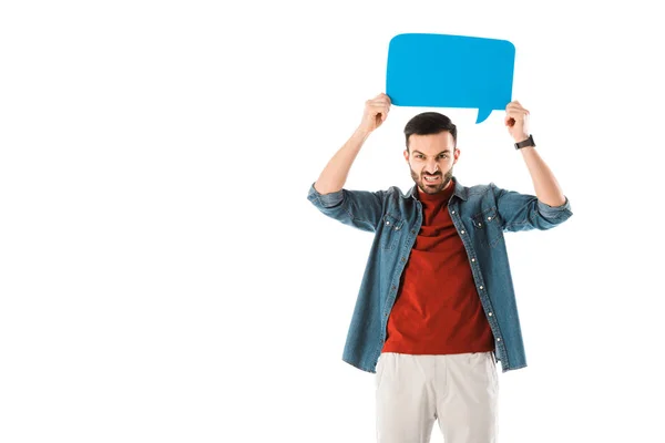 Irritated man holding speech bubble above head and looking at camera isolated on white — Stock Photo