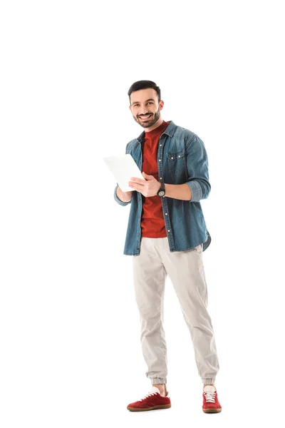 Cheerful handsome man looking at camera while using digital tablet isolated on white — Stock Photo