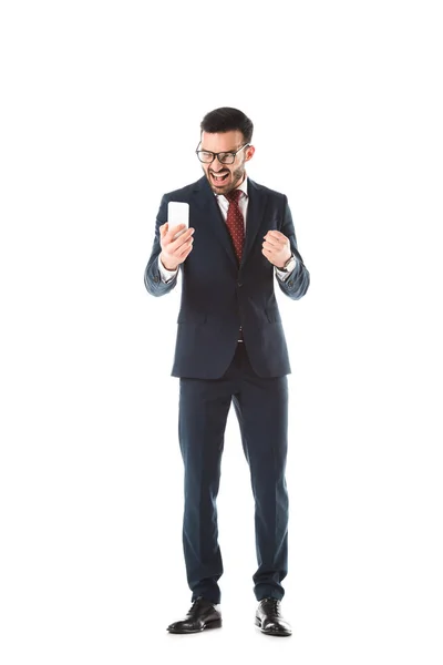 Irritated businessman screaming and showing fist while having video call on smartphone isolated on white — Stock Photo