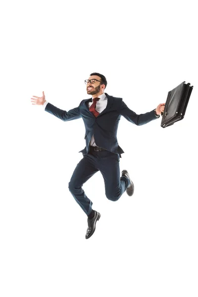 Happy businessman with briefcase jumping and smiling isolated on white — Stock Photo