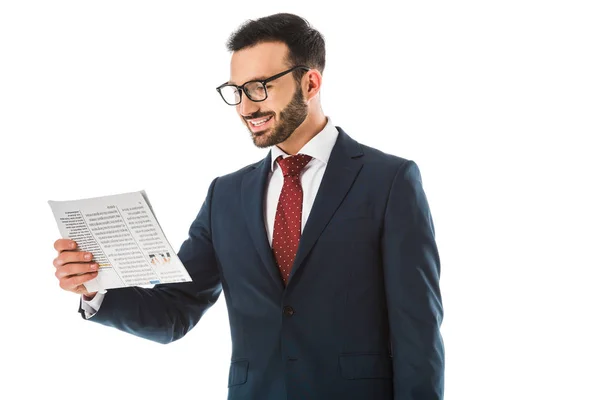 Cheerful businessman in glassed reading newspaper isolated on white — Stock Photo