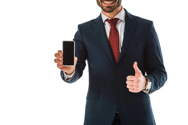 Cropped view of businessman showing thumb up while holding smartphone with blank screen isolated on white — Stock Photo