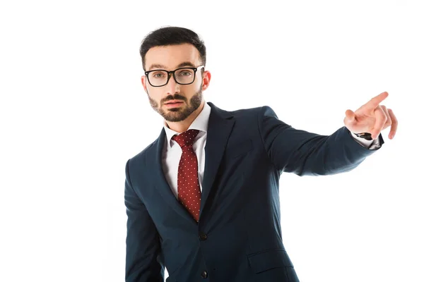 Serious businessman in glasses pointing with finger and looking at camera isolated on white — Stock Photo